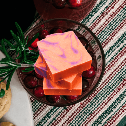 orange and purple bar soap in a bowl of cranberry sauce.