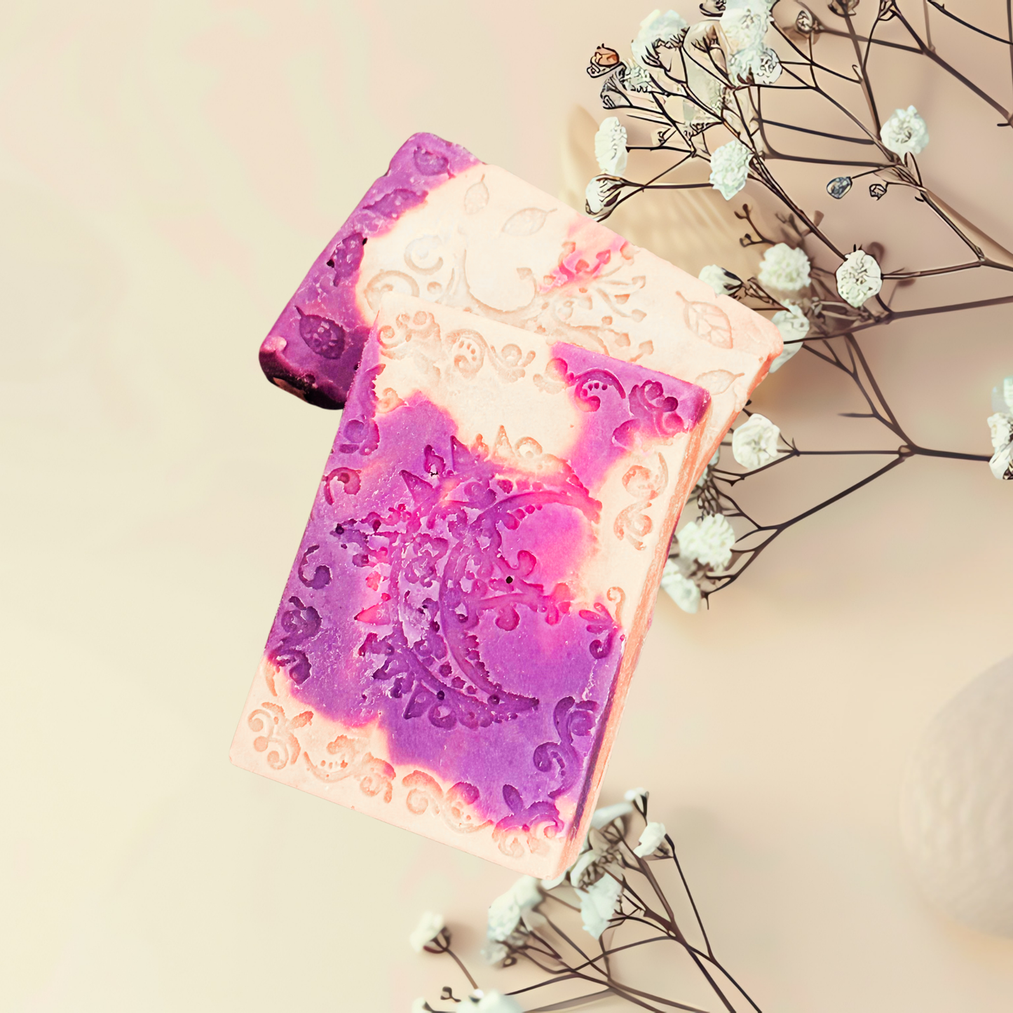 Decorative soap with a purple and pink design on a light background with flowers.