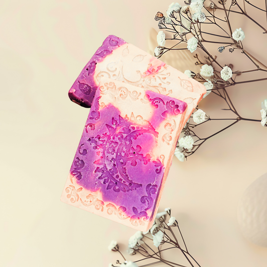 Decorative soap with a purple and pink design on a light background with flowers.