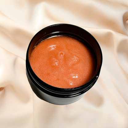 Black container with red scrub on a beige fabric background