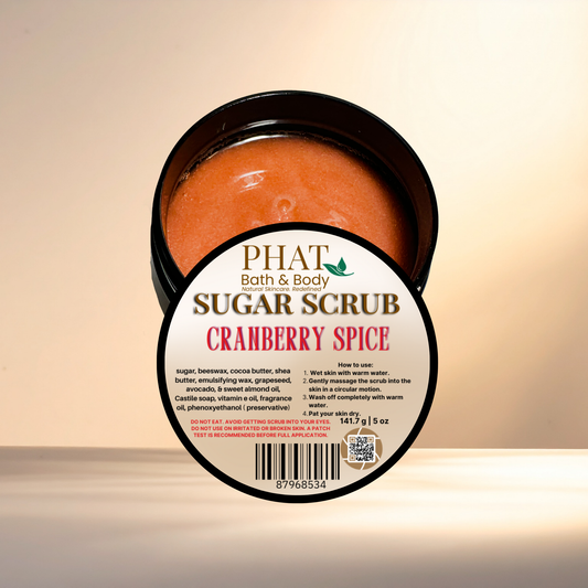 Jar of cranberry spice sugar scrub with 'Phat Bath & Body' label on a beige background