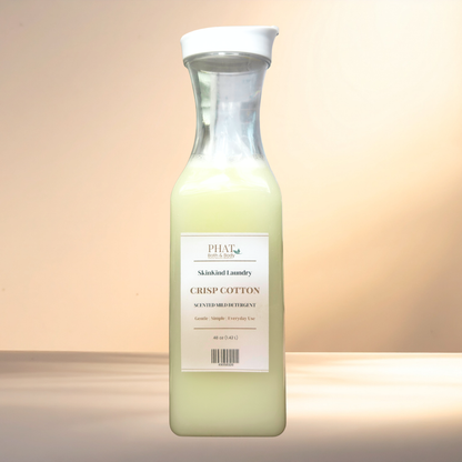 Bottle of Phat Bath & Body SkinKind Laundry Crisp Cotton detergent on a gradient background