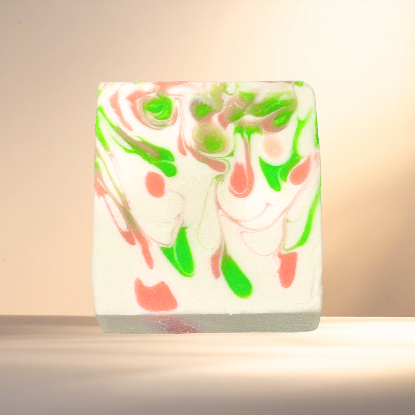 Marbled soap bar with green and pink swirls on a neutral background