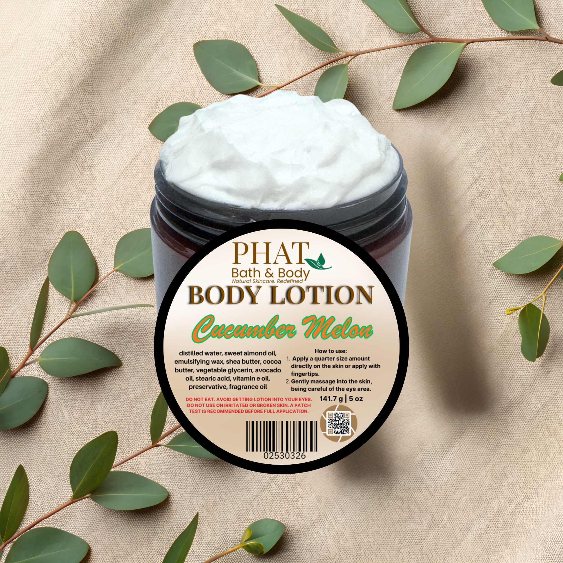 Body lotion jar labeled 'Cucumber Melon' from Phat Bath & Body on a beige fabric background with green leaves.
