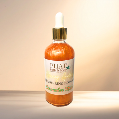 Bottle of 'PHAT Bath & Body' shimmering body oil on a gradient background