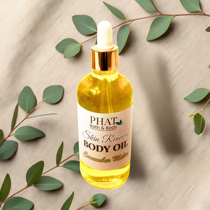 Bottle of PHAT Bath & Body body oil with a dropper on a beige fabric background with green leaves.