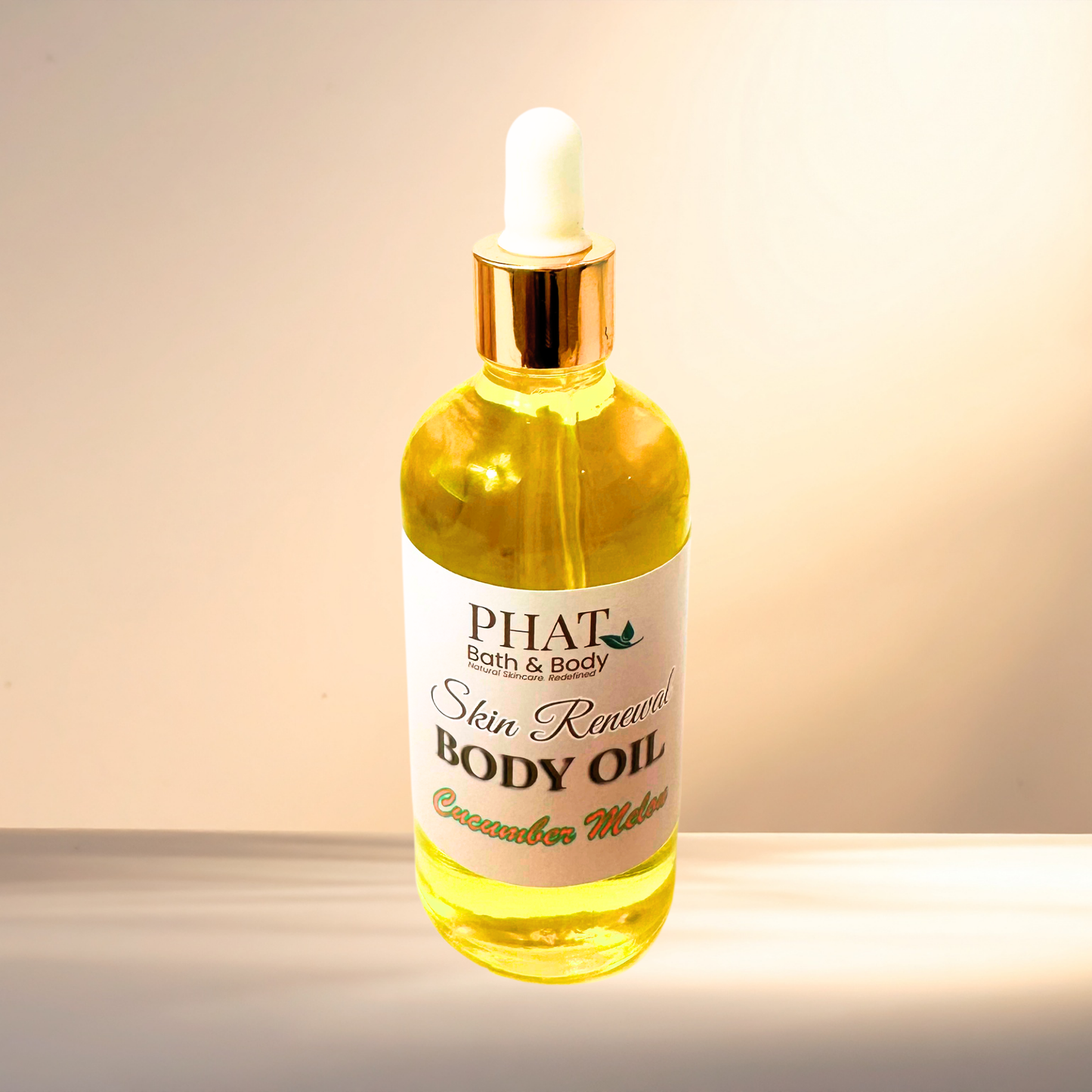 Bottle of Phat Bath & Body body oil with a dropper on a gradient background