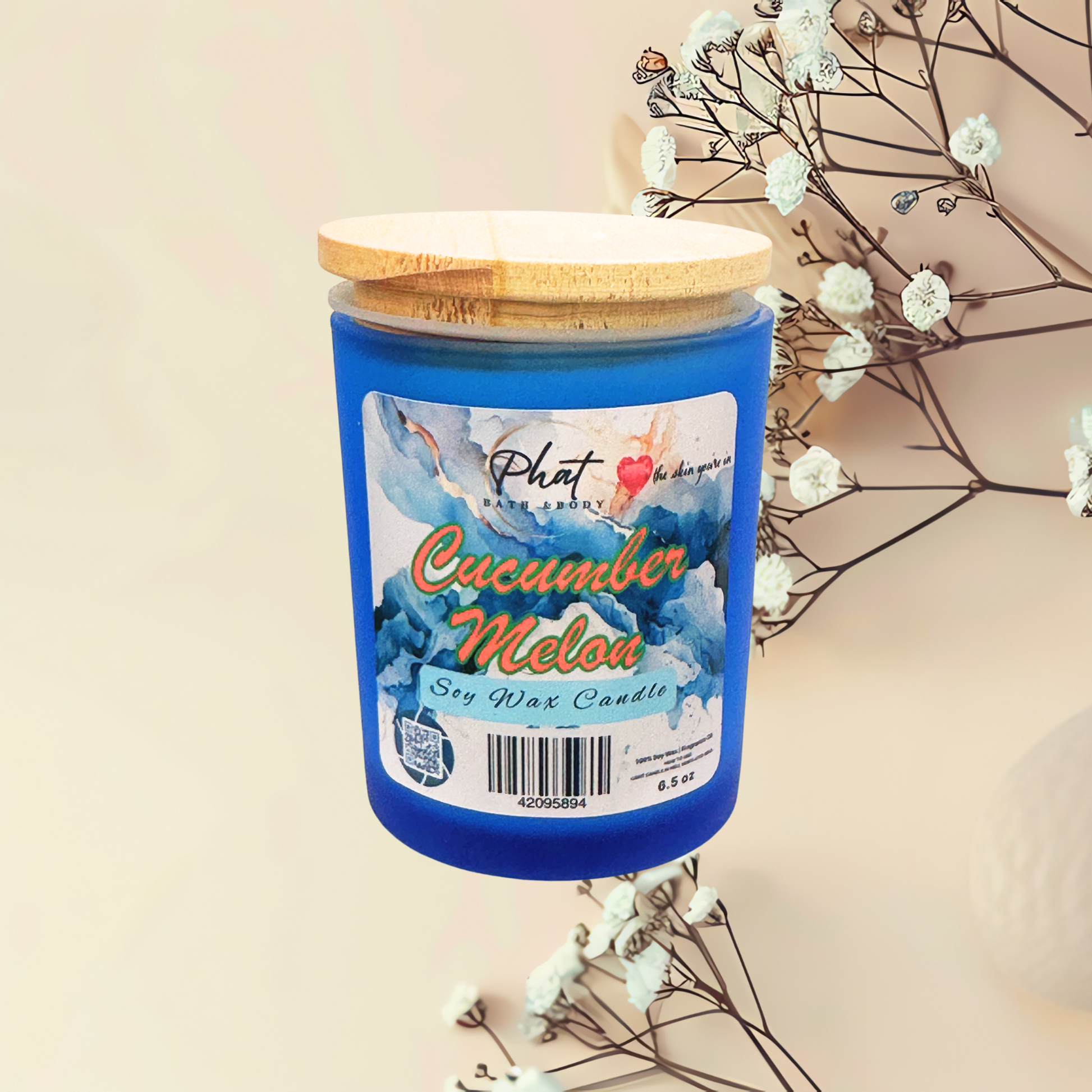 Blue candle labeled 'Cucumber Melon' with a wooden lid on a light background