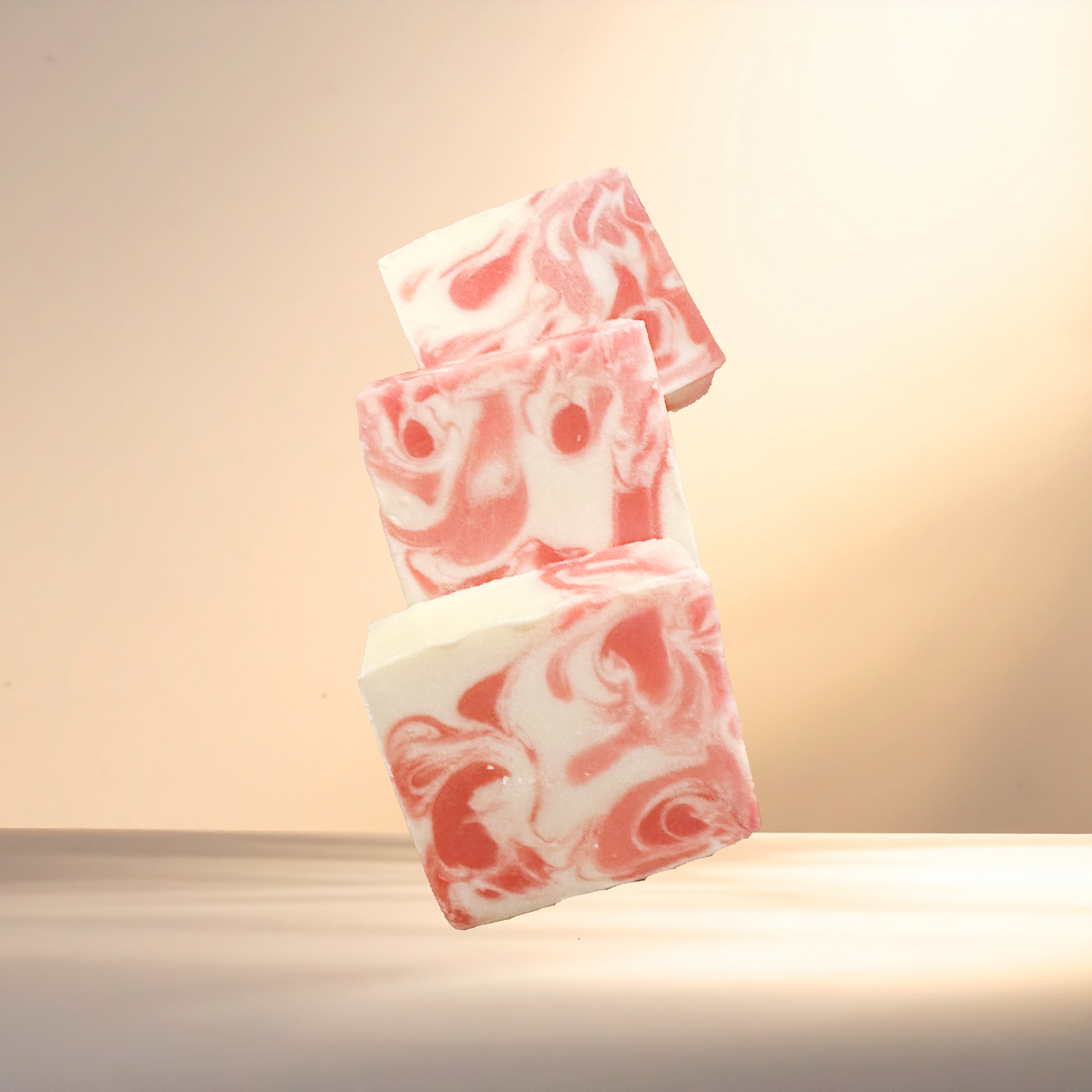 Pink and white marbled soap on a neutral background