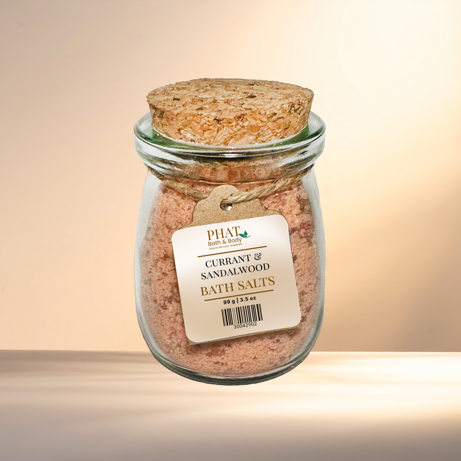 Jar of Currant & Sandalwood Bath Salts with cork lid on a gradient background