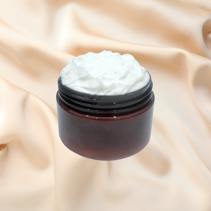 A dark amber cosmetic jar with a black lid, filled with white cream, set against a draped beige satin background.
