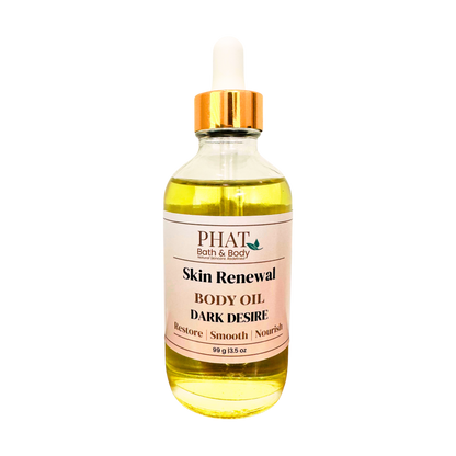 A bottle of PHAT Bath & Body Skin Renewal Body Oil, Dark Desire variant, featuring a clear glass bottle filled with yellow oil, a white dropper cap with a gold collar, and a beige label.
