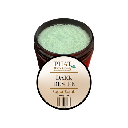 An open amber jar of PHAT Bath & Body 'Dark Desire' sugar scrub, showing the pale mint-green scrub inside, with a round product label in front on a plain white background.