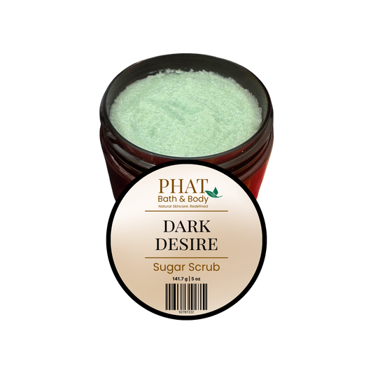 An open amber jar of PHAT Bath & Body 'Dark Desire' sugar scrub, showing the pale mint-green scrub inside, with a round product label in front on a plain white background.