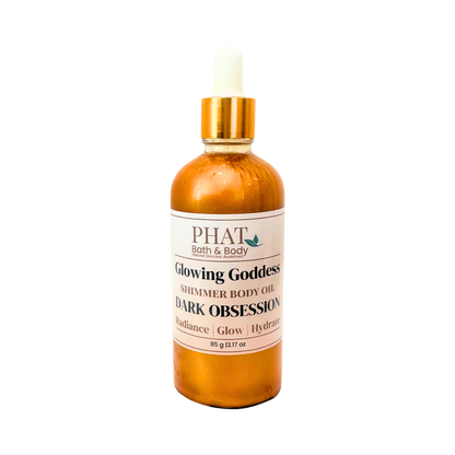 Bottle of 'Glowing Goddess' shimmer body oil by Phat Bath & Body on a white background