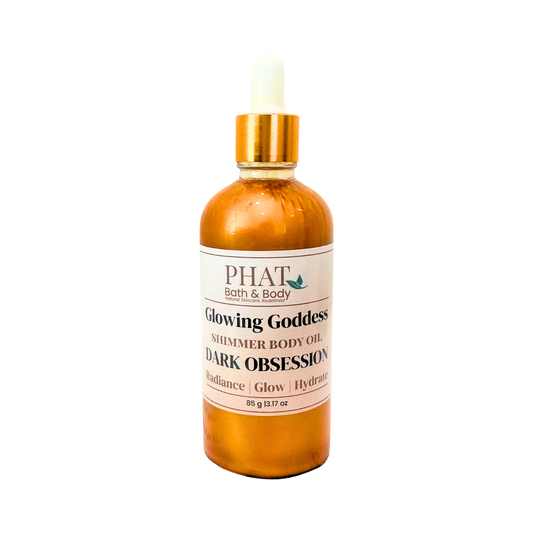 Bottle of 'Glowing Goddess' shimmer body oil by Phat Bath & Body on a white background