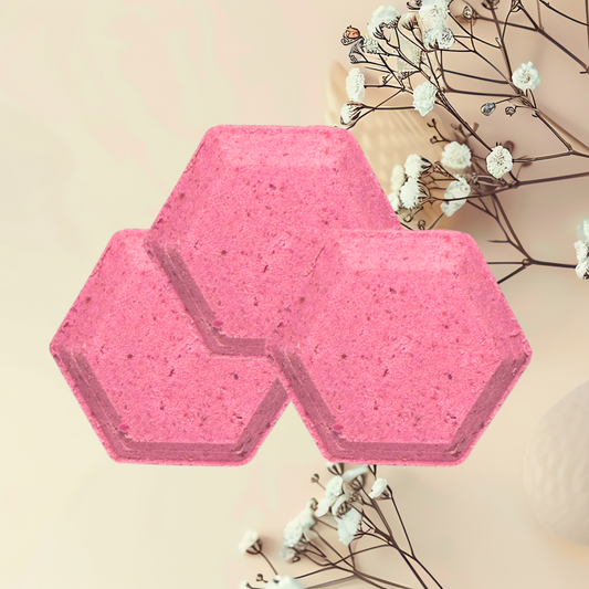 Hexagonal pink steamers on a light surface with white flowers and branches.