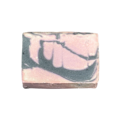 Bar of soap with pink and gray marbled pattern on a white background
