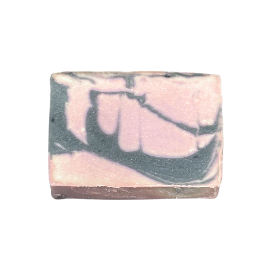 Bar of soap with pink and gray marbled pattern on a white background