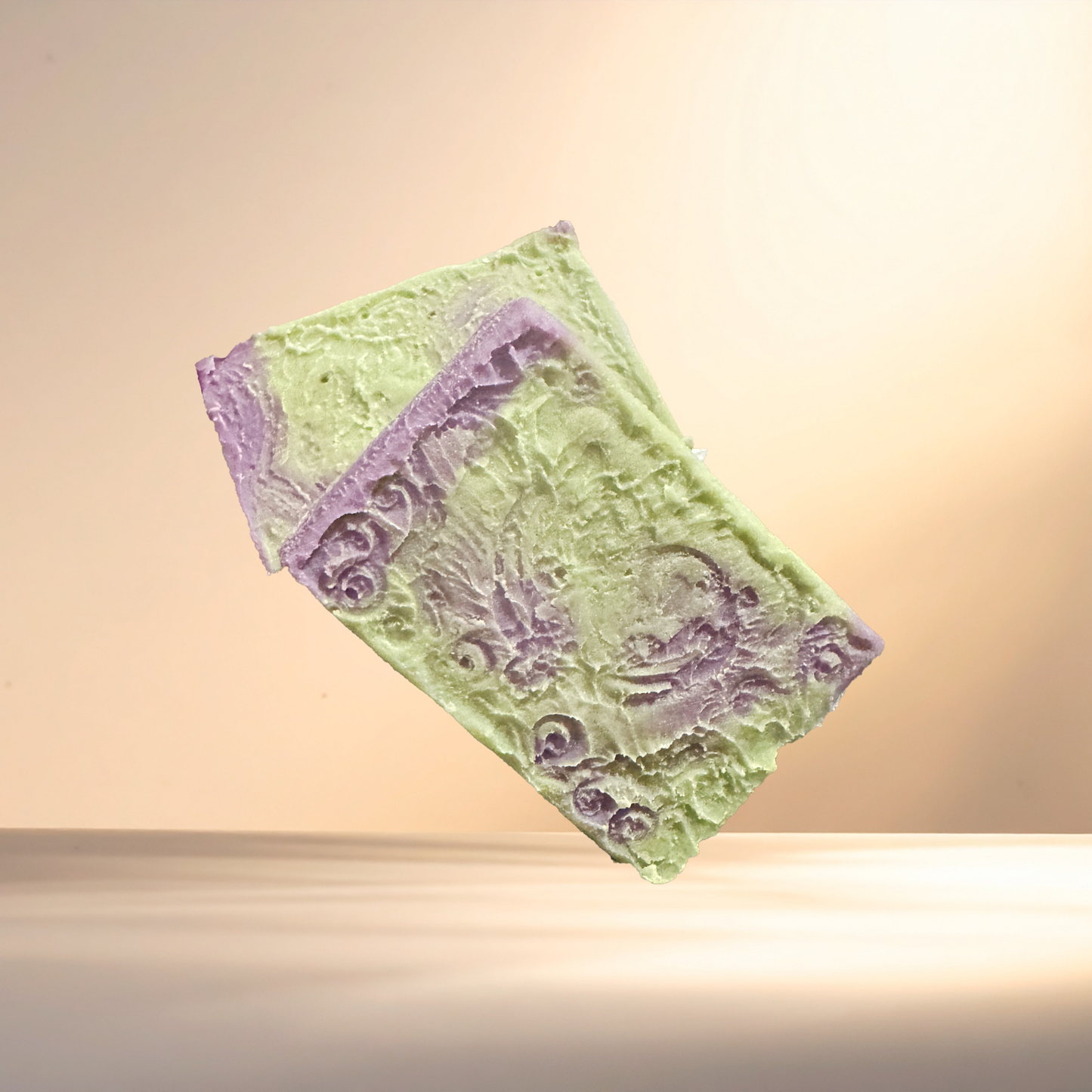 Green soap bar with purple design on a beige background