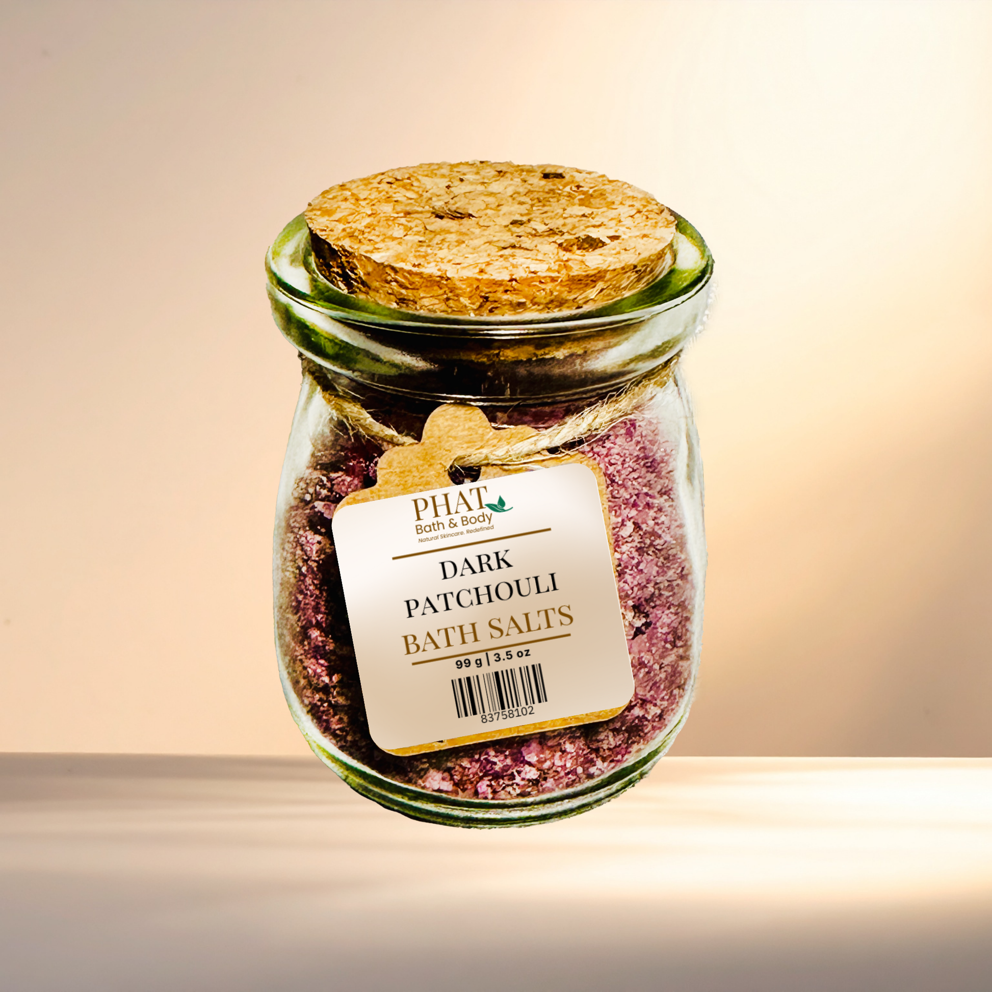 Jar of dark patchouli bath salts with a label on a neutral background