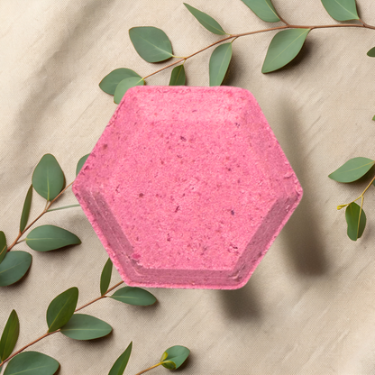 Hexagonal pink steamer with green leaves on a beige fabric background