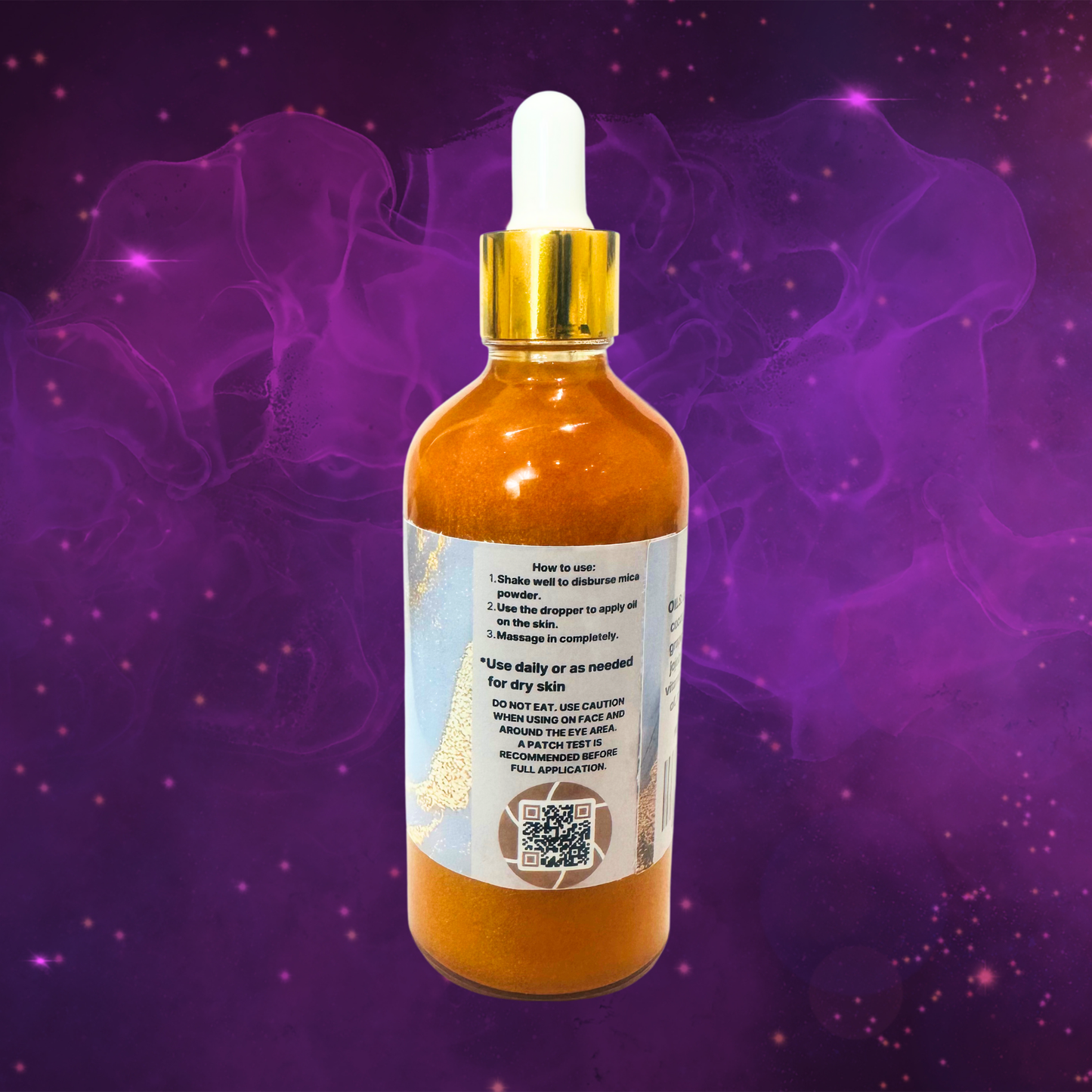 Bottle of gold body oil with dropper on a purple background