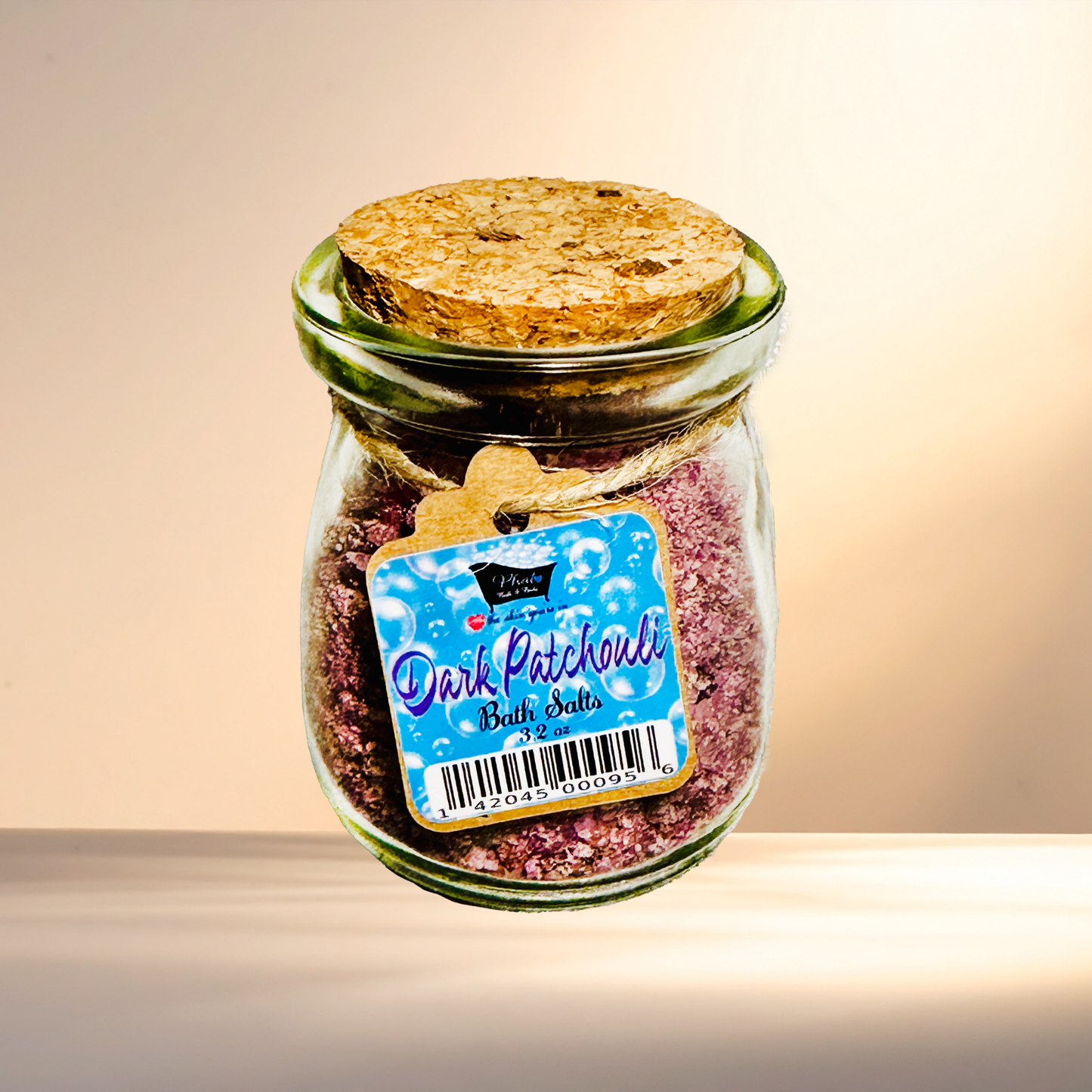 Jar of 'Dark Patchouli' bath salts with a label on a gradient background