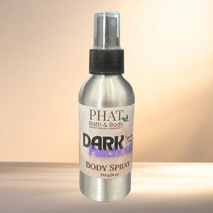 Body spray bottle labeled 'PHAT Bath & Body Dark Patchouli' on a gradient background