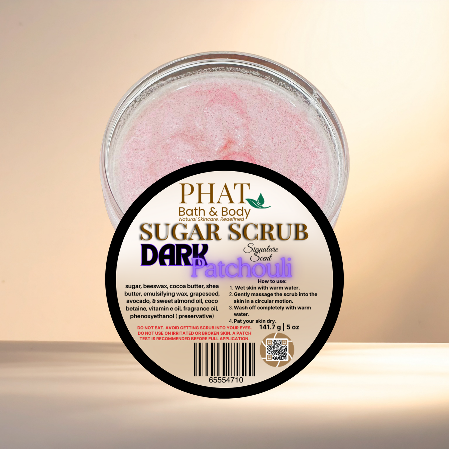 Jar of Phat Bath & Body sugar scrub with a label on a beige background