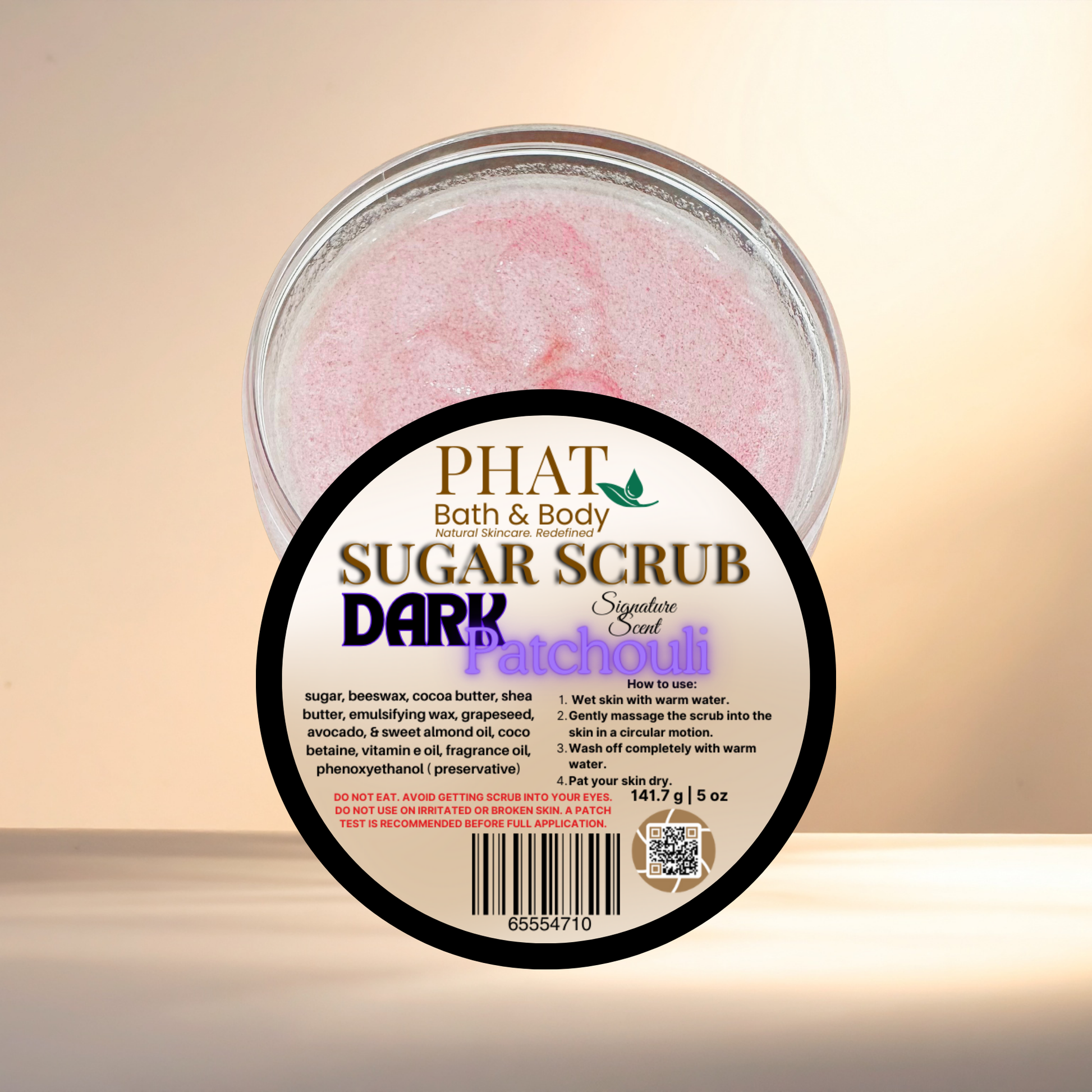 Jar of Phat Bath & Body sugar scrub with a label on a beige background