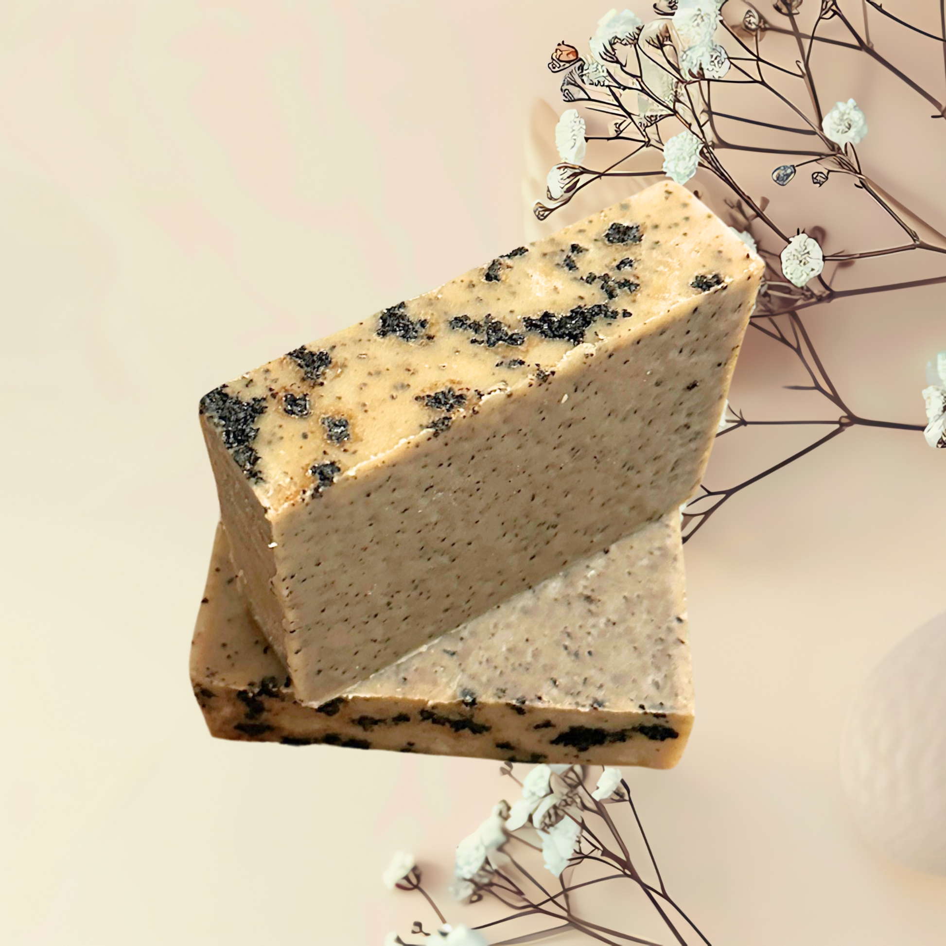 Block of soap with black specks on a light background with decorative elements