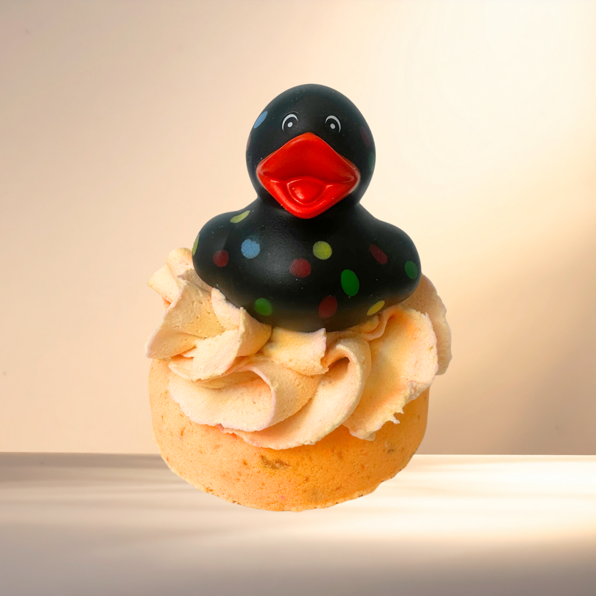 Bubble Bomb with a black rubber duck on top against a beige background