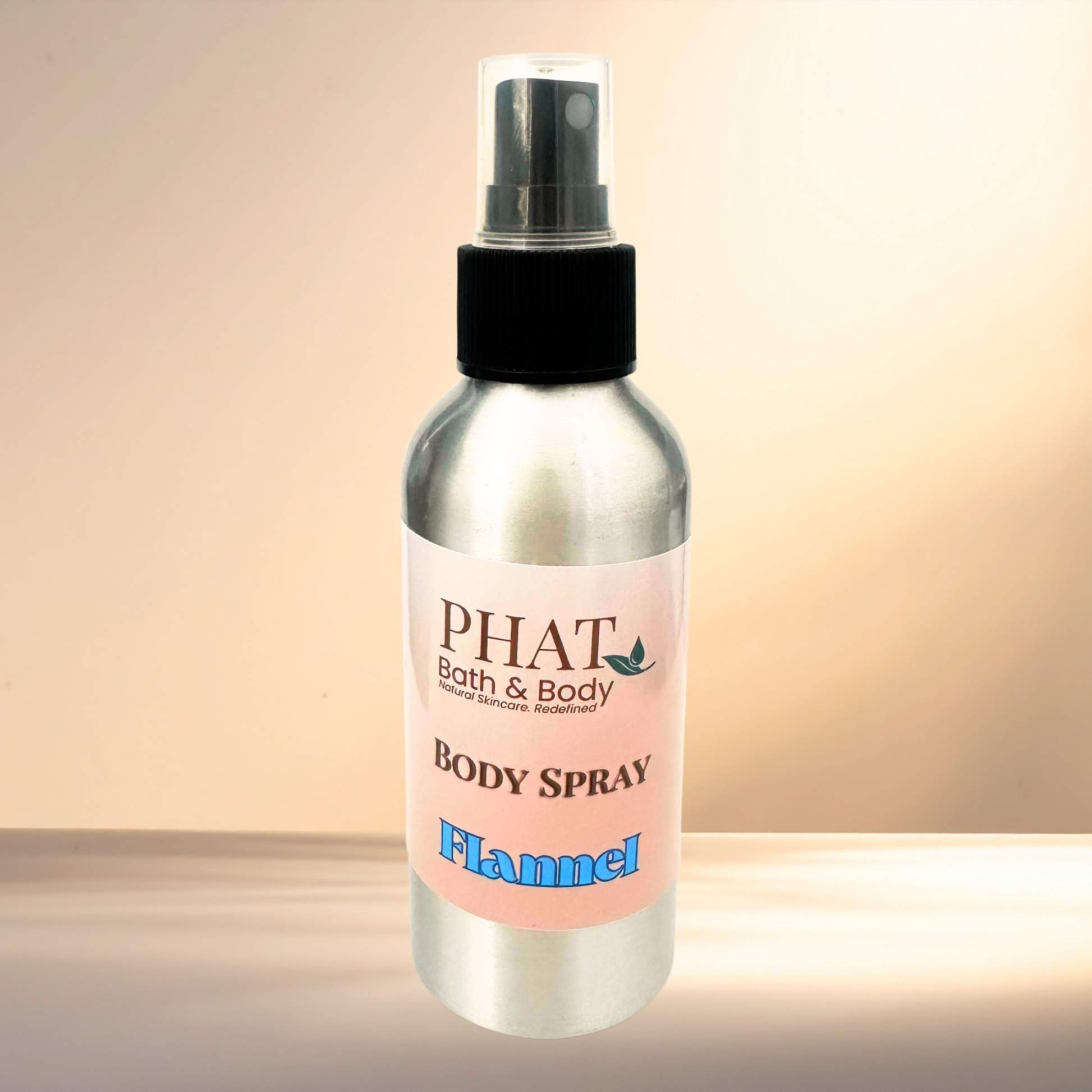 Body spray bottle labeled 'PHAT Bath & Body' on a gradient background
