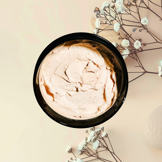 Cosmetic jar with clay mask on a light background with flowers
