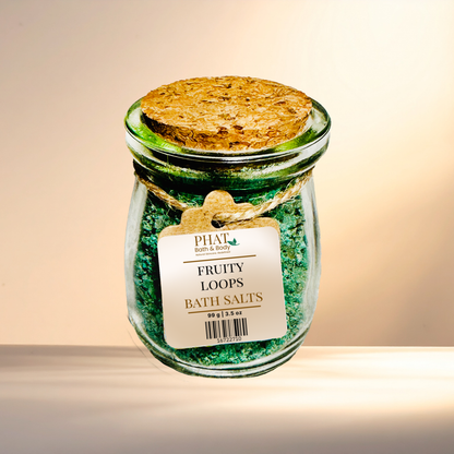 Jar of 'Fruty Loops' bath salts with a cork lid on a neutral background