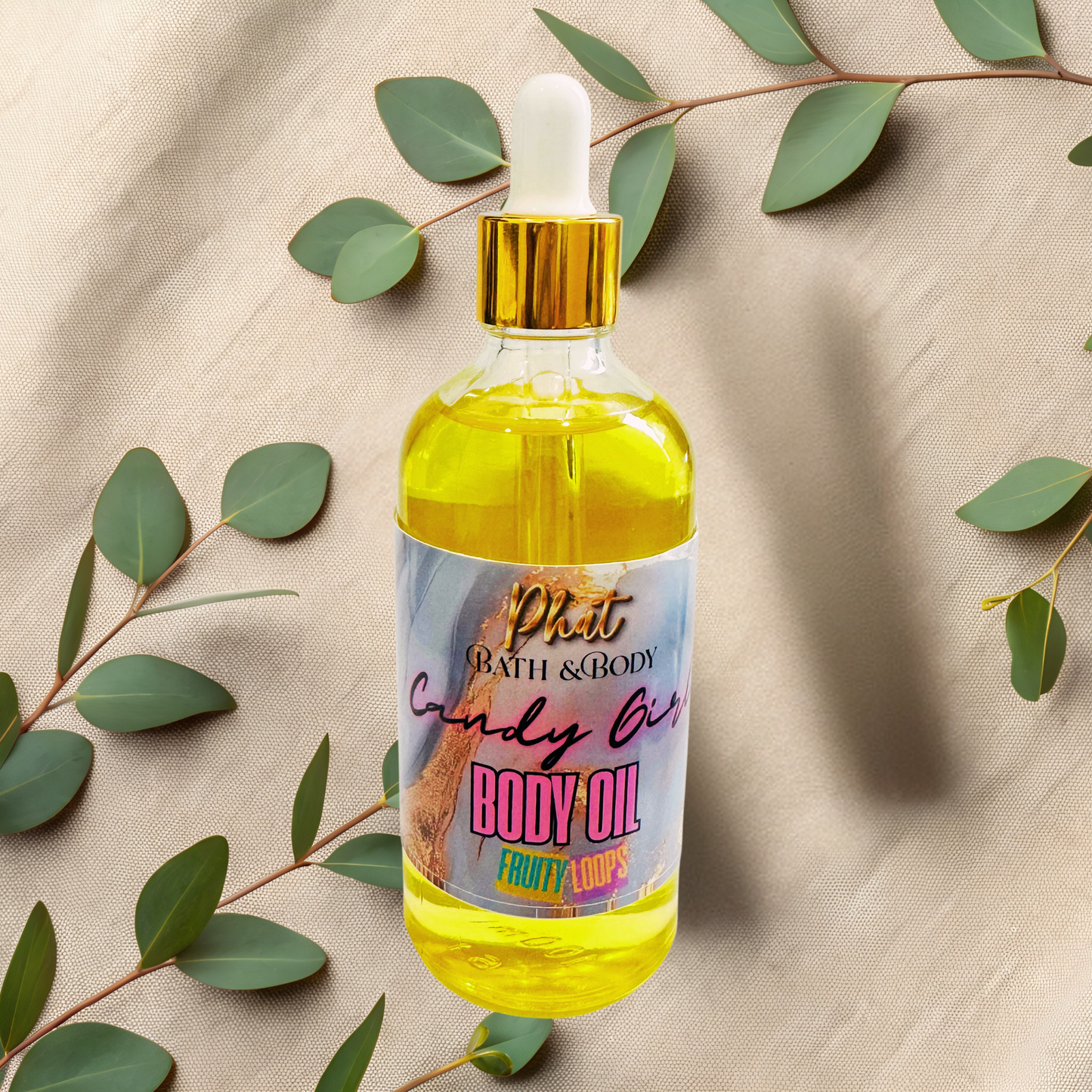 Body oil bottle with dropper on a beige fabric background with green leaves