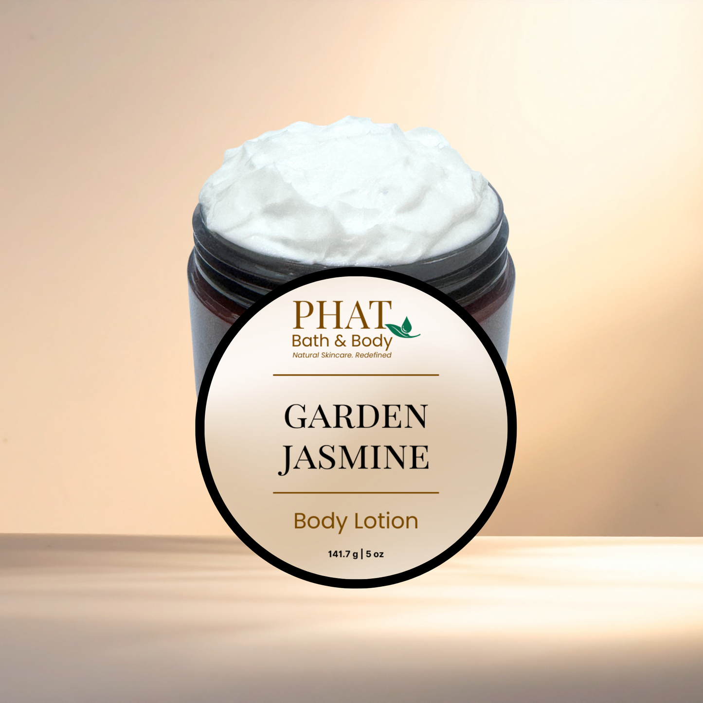 Jar of 'Garden Jasmine' body lotion from PHAT Bath & Body on a beige background