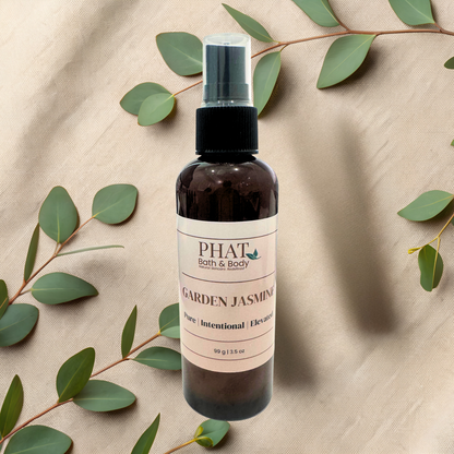 Bottle of 'Garden Jasmine' product by Phat Bath & Body on a textured beige background