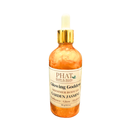 Bottle of 'Glowing Goddess' shimmer body oil by Phat Bath & Body on a white background