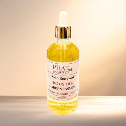 Bottle of Phat Bath & Body Skin Renewal Garden Jasmine body oil on a gradient background
