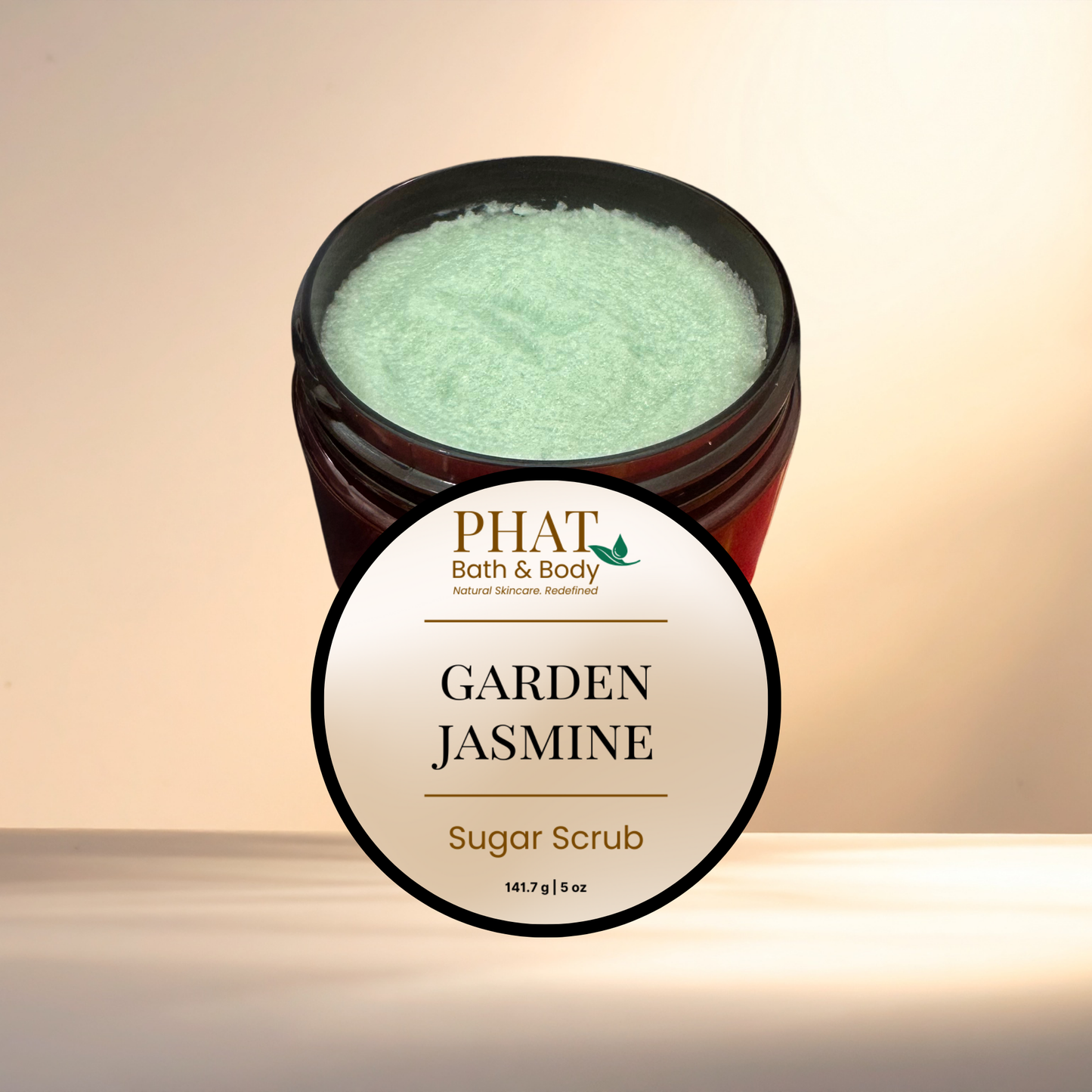 Jar of Garden Jasmine sugar scrub with 'PHAT Bath & Body' label on a beige background