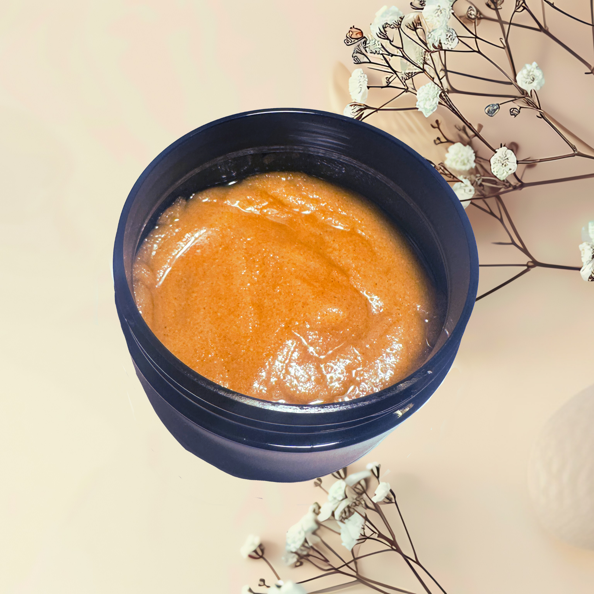 Blue container with orange scrub on a beige background with white flowers