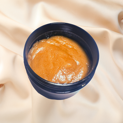 Jar of brown scrub on a beige fabric background