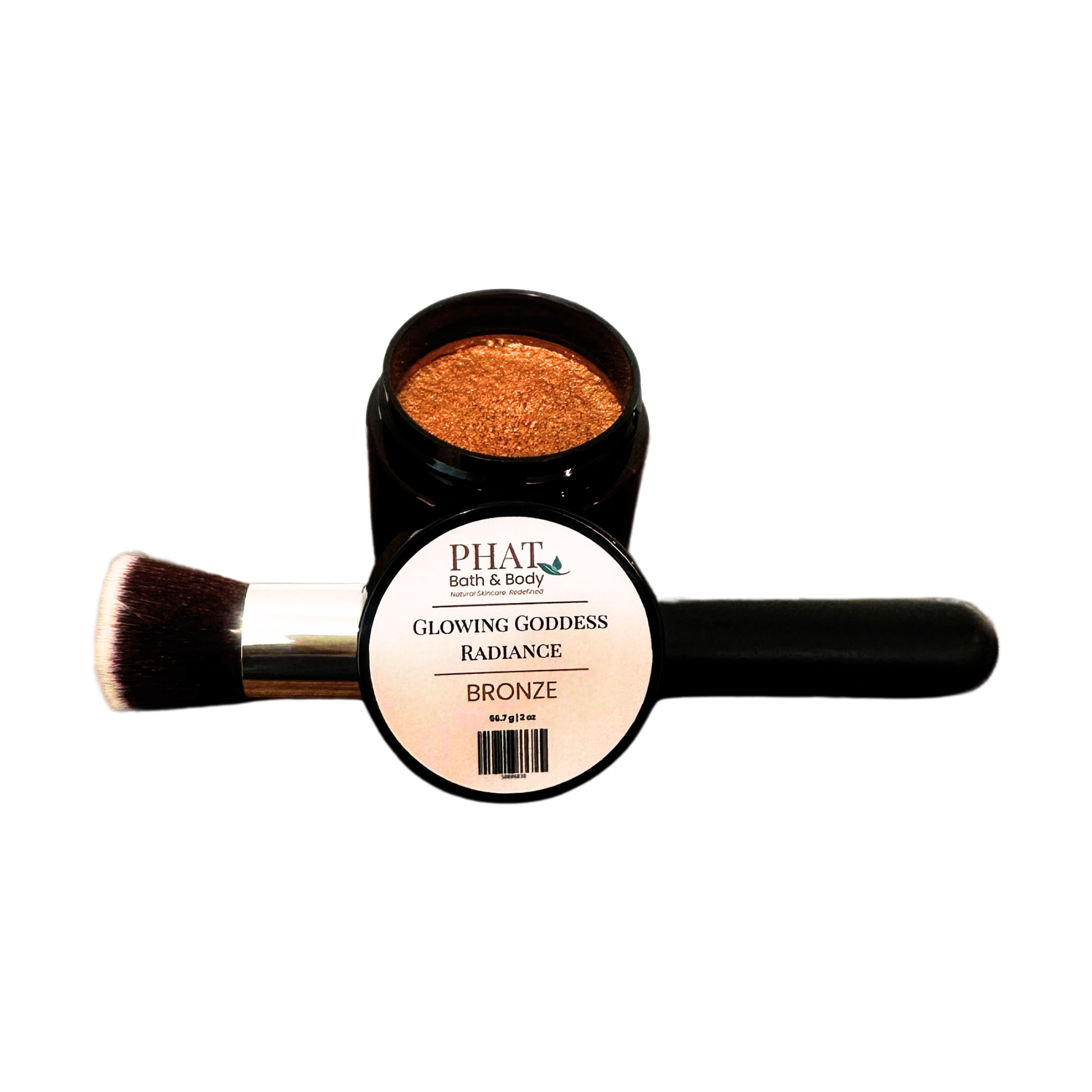 An open jar of PHAT (bath & body) Glowing Goddess Radiance Bronze shimmer powder, with a makeup brush resting across the open lid, on a plain white background.