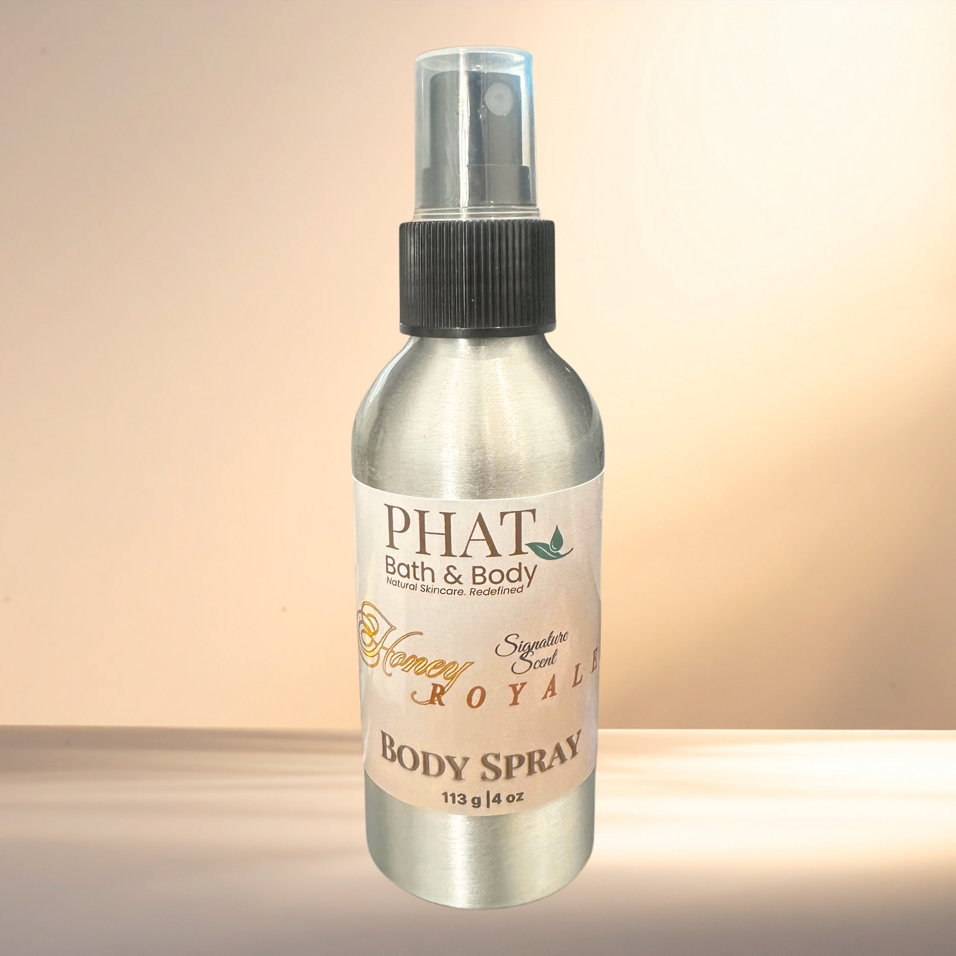 Body spray bottle labeled 'PHAT Bath & Body' on a gradient background