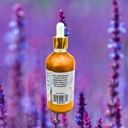 Bottle of shimmer oil with a dropper on a background of lavender flowers