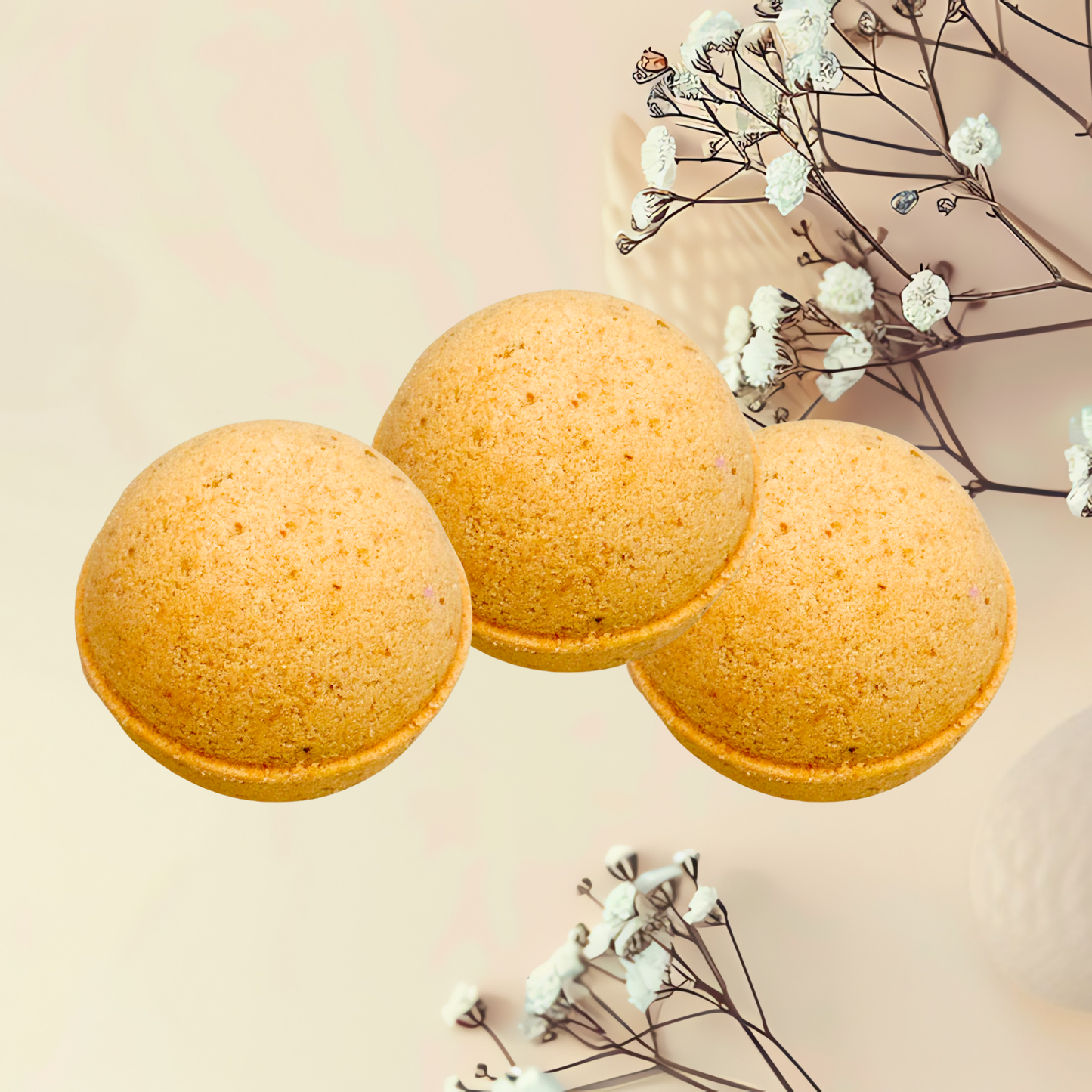 Three round, golden-brown baked goods on a light beige background with white flowers.