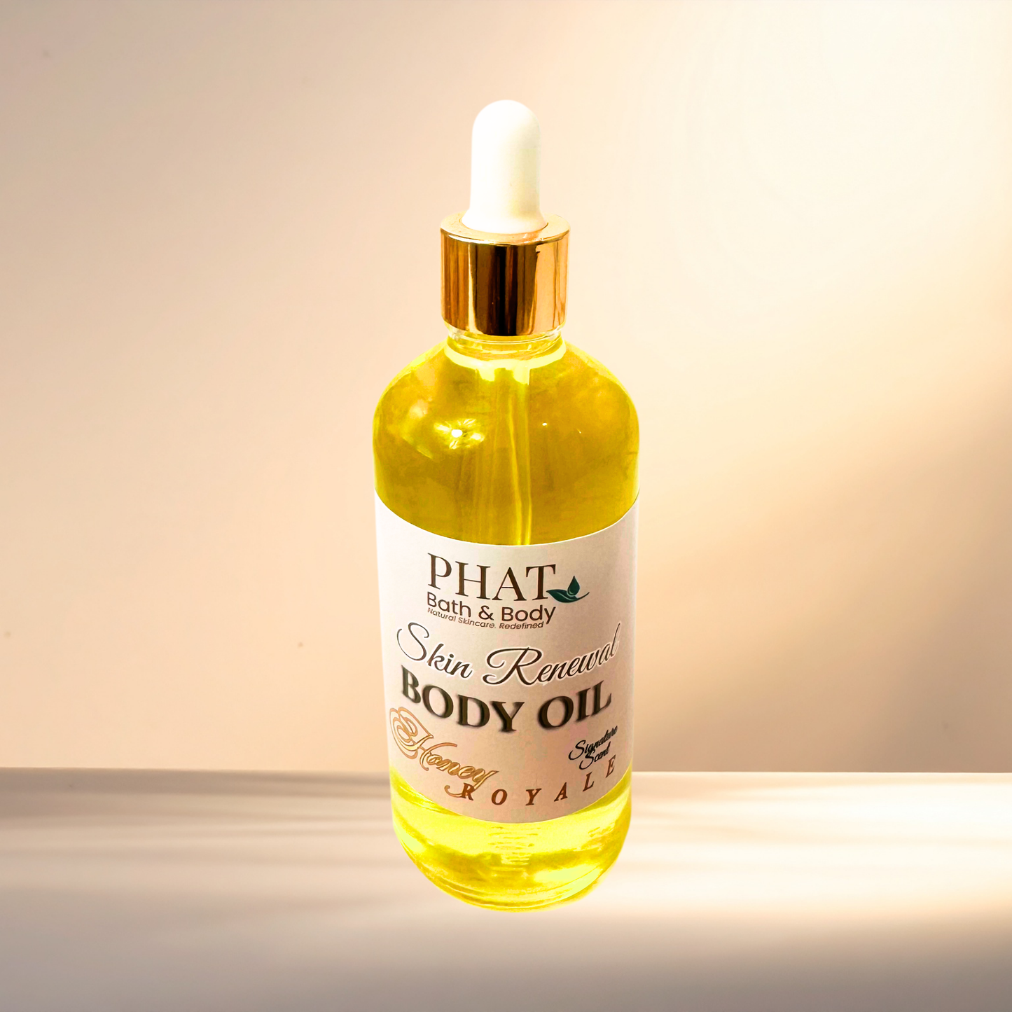 Bottle of PHAT Bath & Body body oil with a dropper on a gradient background
