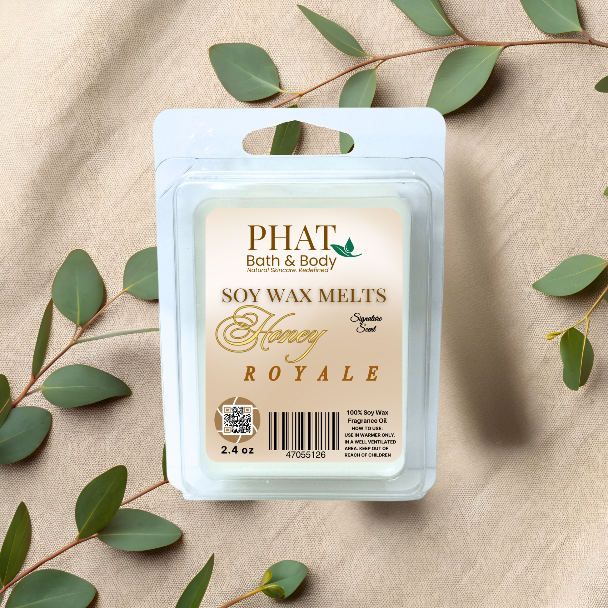 Phat Bath & Body soy wax melt packaging with honey royal scent on a beige fabric background with green leaves.